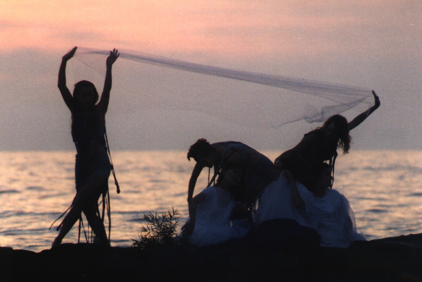 Image of 3 silouettes of MorrisonDancers in front of Lake Erie in their Erie Sirens performance